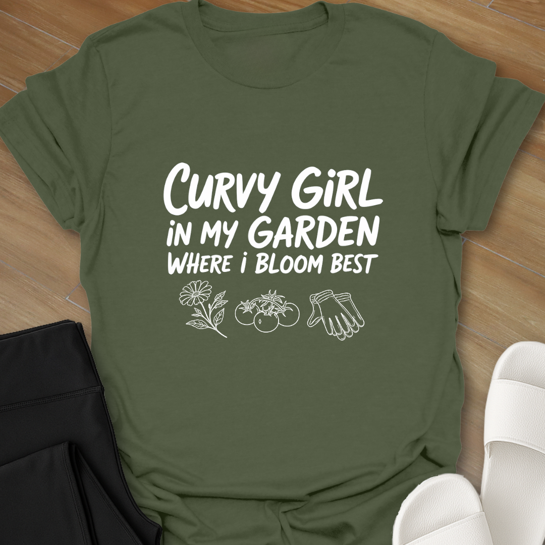 Military green Curvy girl gardening shirt with white hand-lettered text reading “Curvy Girl in My Garden Where I Bloom Best” and garden icons on black background