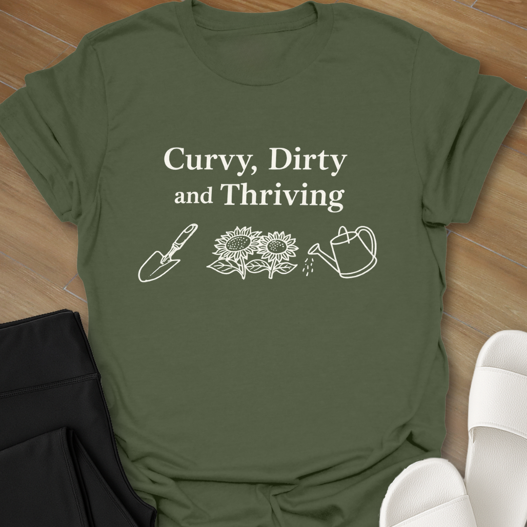  Curvy Dirty and Thriving gardening shirt with serif text and line art of shovel, sunflowers, and watering can on black background