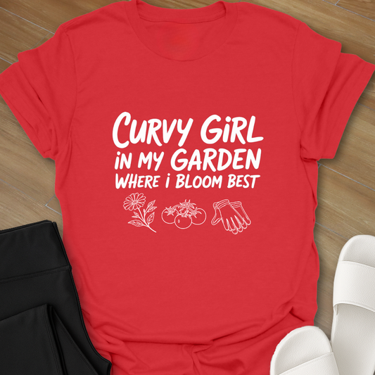 Red Curvy girl gardening shirt with white hand-lettered text reading “Curvy Girl in My Garden Where I Bloom Best” and garden icons on black background
